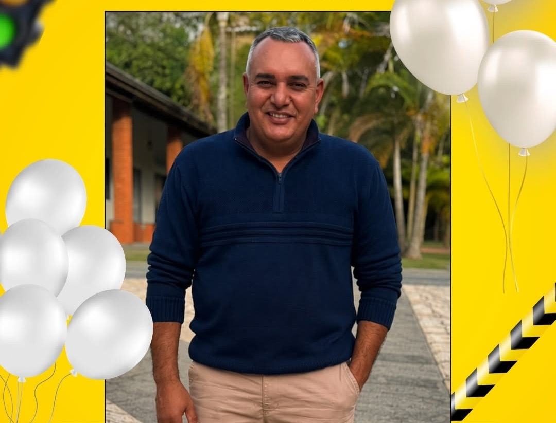 Foto do instrutor Carlos, um homem sorrindo com um carro ao fundo